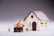 Led lamps and piggy bank lie on a near the house layout
