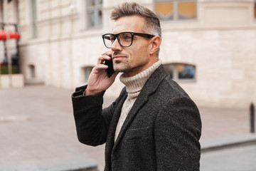 Poster - Handsome man wearing a coat walking