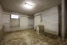 Basement With Sink And Dirty Floor In Old House Interior