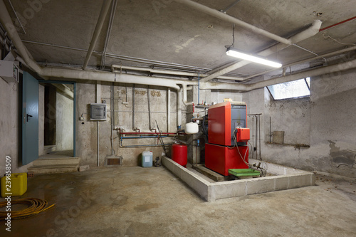 Cuadros en Lienzo Basement with red heating boiler in old house interior