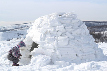 Wall Mural - A child comes into the house of Eskimos-igloo.