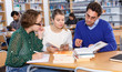 © JackF - Male tutor helping girls in classroom