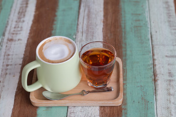 Close up a vintage cup of hot latte coffee on wooden vintage desk, coffee with milk