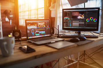Freelance desktop with laptop computer and monitor review for editor work with content video or equipment video of vlog
