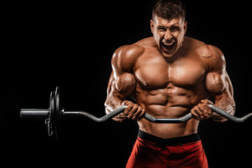 Brutal strong muscular bodybuilder athletic man pumping up muscles with barbell on black background. Workout bodybuilding concept. Copy space for sport nutrition ads.