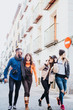 © karrastock - group of friends on the street walking around having fun