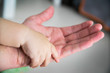 © de Art - the child's hand in the parent's hand