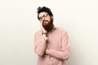 © Vulp - Bored adult man with beardholding hand on cheek and suportingit withanother hand