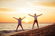 © Margo Basarab - Young happy couple on seashore in the lights of sunset.