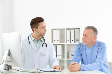 Canvas Print - Doctor working with mature patient in hospital