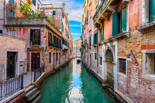 Narrow canal with boat and bridge in Venice, Italy. Architecture and landmark of Venice. Cozy cityscape of Venice. © Ekaterina Belova