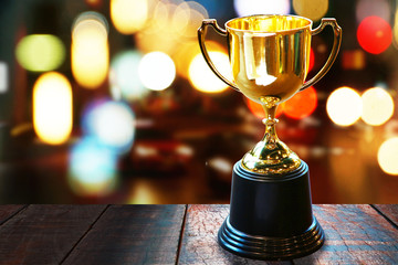 Wall Mural - trophy on wood table with abstract bokeh background