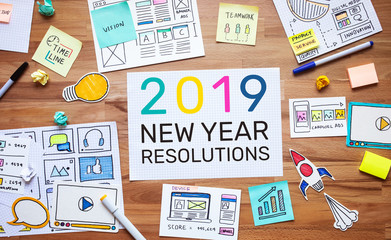 Wall Mural - 2019 new year resolutions with business digital marketing and paperwork sketch on wood table.analysis strategy concepts