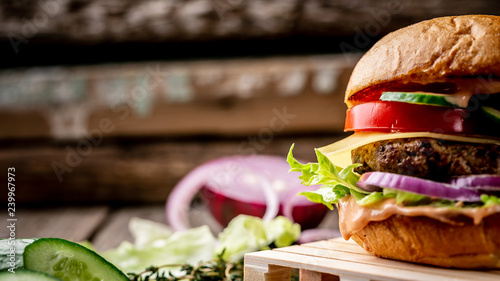 Cuadros en Lienzo fragment of homemade tasty hamburger on wooden vintage table
