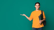 © Prostock-studio - Happy student with books holding something on palm