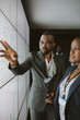 © JonoErasmus - African business man pointing onto digital screen for a presentation