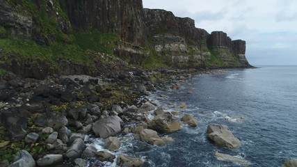 Wall Mural - low angle drone shot of steep mountain cliffs and rock formations on trotternish peninsula, located 