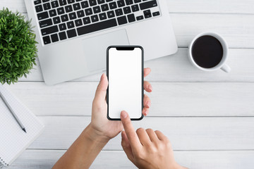 Poster - Hand using smartphone on white wooden background