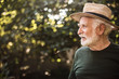 © Yakobchuk Olena - Old aged man standing in profile against background of trees