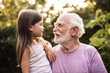 © Yakobchuk Olena - Granddaughter talking with her grandfather in park