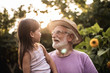 © Yakobchuk Olena - Granfather with his granddaughter spending vacation in countryside