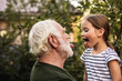 © Yakobchuk Olena - Senior bearded man having fun with his granddaughter