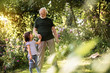 © Yakobchuk Olena - Grandfather leading his granddaughter to work in garden