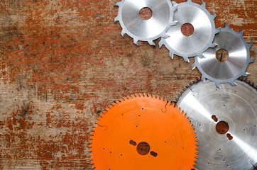 Canvas Print - Flatly composition carpentry tools on an old board, circular saws.