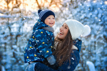 Woman and child in winter in nature. Portrait of a happy family