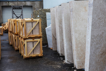 Wall Mural - Side view of the edge of the granite slab in bulk. A stack of granite slabs - marble factory. Background of marble slabs. Natural stone. Background of granite slabs. Granite slabs ready for sale