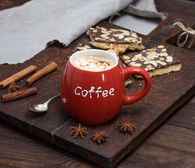 black coffee with marshmallow in a red ceramic mug