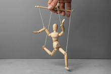 The Puppeteer Holds The Doll By The Rope. The Doll Does Not Obey The Puppeteer.
