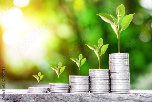 Cuadros en Lienzo Close up of stacking gold coins with green bokeh background ,Business Finance an