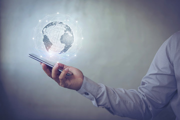 Poster - business man hand holding smart phone with virtual screen World map , network connection, international meaning, copy space