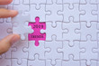 © Jo Panuwat D - Woman Hand holding white jigsaw puzzle piece with words 2019 TRENDS. Business resolutions, success, goals, New Year New Start and strategy concept