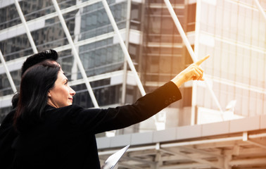 Business women pointing finger in office building. Business concept.