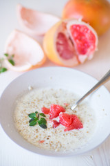 Poster - sweet oatmeal with slices of red grapefruit in a ceramic bowl