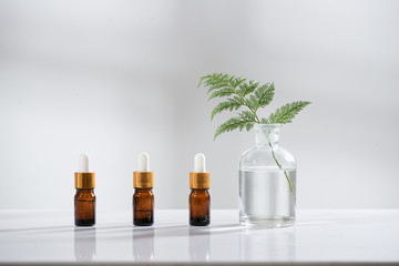 Wall Mural - the bio laboratory glassware and blank cosmetic bottle containers with herbal flower ingredient,pack