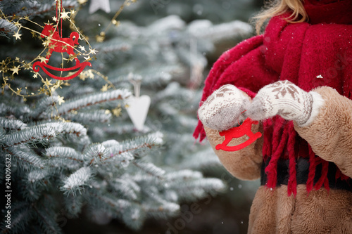 A Young Woman Holds Decorations For The Christmas Fir In The Shape