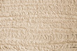 Texture of wet gypsum plaster applying to the aerated concrete wall with a spray plastering machine. Plastering structure close-up. Internal finishing background.