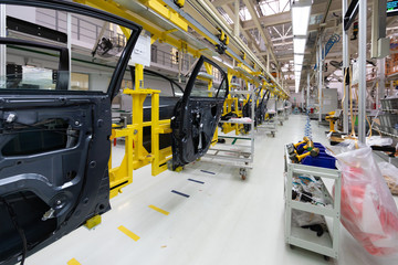 Wall Mural - car door on conveyor. Robotic equipment makes Assembly of car. Modern car Assembly at factory