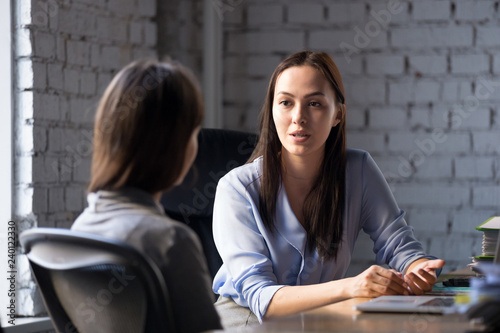 Fotomural Serious professional female advisor consulting client at meeting talking having