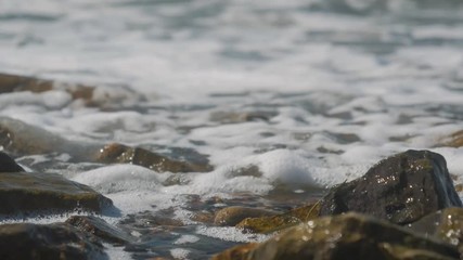 Wall Mural - The waves crashing against the rock on the sea shore