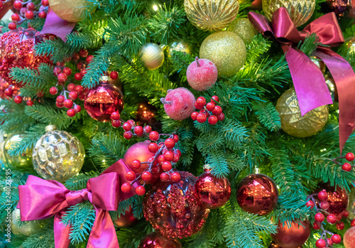 Christmas tree decorated with colorful toys bows and berries. Christmas background. © Valemaxxx