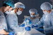 © alfa27 - Surgery preparations. Surgical team preparing their patient for surgery adjusting oxygen mask on face at the operating theare. healthcare surgery professionals team doctors.