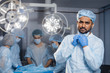 © alfa27 - Confident Indian surgeon looking at camera in surgical room hospital, medical doctor wear green surgery scrub suit.