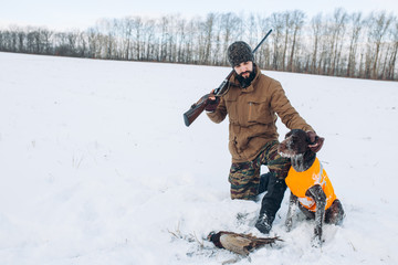 Wall Mural - hunter likes his dog. handsome man looking at his tired dog after hunting. full length photo.