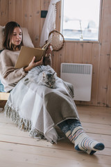 Wall Mural - Girl relaxing with cat in cabin