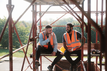 happy workers in construction site during lunch break