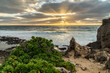 God rays created by clouds covering the sun at Makawehi Bluff, Kauai, Hawaii